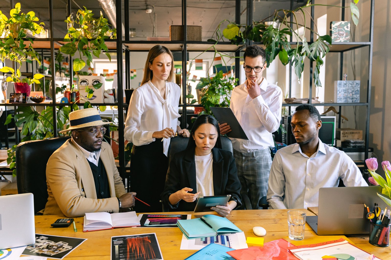 Multicultural five-person business team collaborating