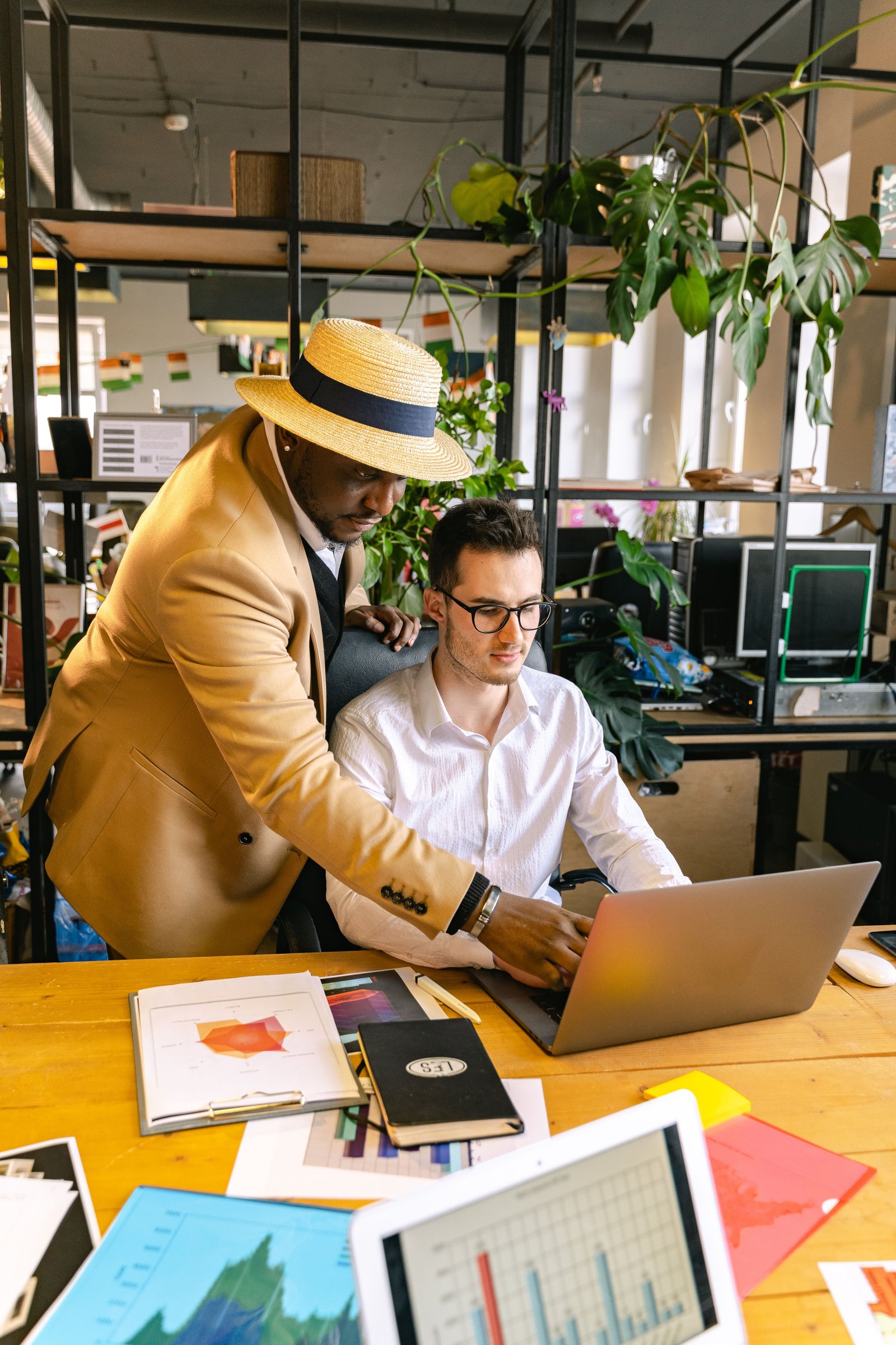 Two businessmen working together at a laptop